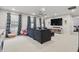 Spacious living room featuring a gray sectional, large windows and a TV at 7391 Blanford Dr, Plainfield, IN 46168