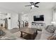 Cozy living room with hardwood floors, staircase, and a stylish entertainment center at 7391 Blanford Dr, Plainfield, IN 46168