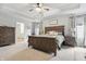 Spacious main bedroom features a wooden bed frame, trey ceilings, and carpet at 7391 Blanford Dr, Plainfield, IN 46168