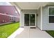 View of back patio with sliding glass door and well-maintained lawn at 745 Stone Trace Ct, Avon, IN 46123
