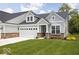 Charming home with a two-car garage and well-manicured lawn at 745 Stone Trace Ct, Avon, IN 46123