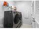 Laundry room with a washer, dryer, storage shelf and white door at 745 Stone Trace Ct, Avon, IN 46123