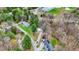 Aerial view highlights houses nestled among lush trees with a view of the lake in the background, creating a serene environment at 7469 Lion Dr, Nineveh, IN 46164
