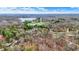 Extensive aerial view captures a tranquil lake, lush forests, and scattered residences under a clear sky at 7469 Lion Dr, Nineveh, IN 46164