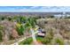 Scenic aerial view featuring a charming blue house nestled among lush trees with views of the lake and surrounding landscape at 7469 Lion Dr, Nineveh, IN 46164