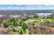 Aerial view showcases a tranquil lake and community surrounded by lush greenery, offering stunning views of the waterfront property at 7469 Lion Dr, Nineveh, IN 46164