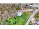 Aerial shot of a modern house surrounded by verdant trees with a long driveway and well maintained lawn at 7469 Lion Dr, Nineveh, IN 46164