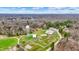 Expansive aerial shot highlights a serene lake and a park featuring an athletic field, all enveloped by a lush landscape at 7469 Lion Dr, Nineveh, IN 46164