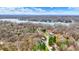 Breathtaking aerial view of a charming lakeside community surrounded by lush, dense trees and calm blue waters at 7469 Lion Dr, Nineveh, IN 46164