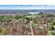 Breathtaking aerial view captures a serene lake and lush greenery that surrounds the beautiful houses and the park in the landscape at 7469 Lion Dr, Nineveh, IN 46164