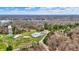 Captivating aerial view highlighting a serene lake and a park with athletic facilities set against a lush forest backdrop at 7469 Lion Dr, Nineveh, IN 46164