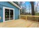 A wooden deck with wooden railing is attached to the home with sliding glass door at 7469 Lion Dr, Nineveh, IN 46164