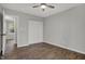 A bright bedroom is adorned with hardwood floors, a ceiling fan, and closet with bright white doors at 7469 Lion Dr, Nineveh, IN 46164