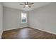 An illuminated bedroom has hardwood floors, neutral-colored walls, and a window at 7469 Lion Dr, Nineveh, IN 46164