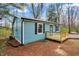 Side view of charming blue home with new deck, black shutters, metal roof and black gutters and downspouts at 7469 Lion Dr, Nineveh, IN 46164