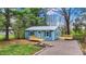 Charming blue home featuring a metal roof, dark shutters, and newly constructed wooden porches in a wooded lot at 7469 Lion Dr, Nineveh, IN 46164