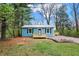 Charming blue home featuring a metal roof, dark shutters, and newly constructed wooden porches in a wooded lot at 7469 Lion Dr, Nineveh, IN 46164
