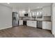 Bright kitchen with hardwood floors, stainless appliances, white cabinetry, and butcher block countertops and tile backsplash at 7469 Lion Dr, Nineveh, IN 46164
