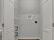 Inside a bright laundry area, you will find washer and dryer hookups and installed shelving at 7469 Lion Dr, Nineveh, IN 46164