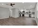 Spacious living room with hardwood floors, recessed lighting, and ceiling fan, flowing into a modern kitchen area at 7469 Lion Dr, Nineveh, IN 46164