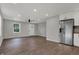 Bright living room with hardwood floors, recessed lighting, and a stainless steel refrigerator in an open layout at 7469 Lion Dr, Nineveh, IN 46164