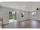 Open living room with new plank flooring, recessed lighting, ceiling fan and sliding doors to the new deck at 7469 Lion Dr, Nineveh, IN 46164