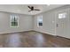 Bright living room with hardwood floors, recessed lighting, and a modern ceiling fan, highlighting ample natural light at 7469 Lion Dr, Nineveh, IN 46164