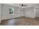 Bright living room with hardwood floors, recessed lighting, and a modern ceiling fan, with an adjacent entry door at 7469 Lion Dr, Nineveh, IN 46164