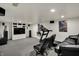 Basement features a flat screen TV, speakers, a treadmill, and comfortable seating at 7531 Normandy Blvd, Indianapolis, IN 46278