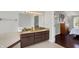 Bathroom featuring a double sink vanity with granite countertop and dark wood cabinets at 7531 Normandy Blvd, Indianapolis, IN 46278