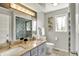 Bathroom boasting double sinks, granite countertop, and a tiled shower with glass door at 7531 Normandy Blvd, Indianapolis, IN 46278