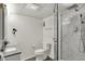 Updated bathroom with tiled shower stall, new toilet, updated lighting and gray tile flooring at 7531 Normandy Blvd, Indianapolis, IN 46278