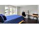 Bright bedroom featuring a wooden desk, sleek black chair, and a cozy blue-covered bed at 7531 Normandy Blvd, Indianapolis, IN 46278