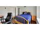Cozy bedroom with hardwood floors, blue bedding, and a work area with a desk and chair at 7531 Normandy Blvd, Indianapolis, IN 46278