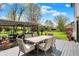 Scenic deck with outdoor dining area and a view of the expansive, well-maintained backyard and vibrant landscaping at 7531 Normandy Blvd, Indianapolis, IN 46278