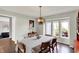 Bright dining room featuring an elegant chandelier, large windows, and neutral decor at 7531 Normandy Blvd, Indianapolis, IN 46278