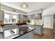 Well-lit kitchen with stainless steel appliances, gray cabinets and island cooktop at 7531 Normandy Blvd, Indianapolis, IN 46278