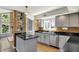 Open kitchen with granite countertops, sleek appliances, mosaic backsplash, and adjacent living area at 7531 Normandy Blvd, Indianapolis, IN 46278