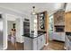 Stylish kitchen featuring an island cooktop, brick accents, and stainless steel appliances at 7531 Normandy Blvd, Indianapolis, IN 46278