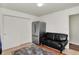Cozy living room featuring a black sofa, stainless steel refrigerator, and white closet at 7531 Normandy Blvd, Indianapolis, IN 46278