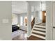 Living room with hardwood floors, staircase, and abundant natural light at 7531 Normandy Blvd, Indianapolis, IN 46278