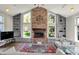 Inviting living room with brick fireplace, vaulted ceilings, and built-in shelving at 7531 Normandy Blvd, Indianapolis, IN 46278