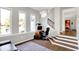 Bright living room with large windows, sleek hardwood floors, and modern staircase at 7531 Normandy Blvd, Indianapolis, IN 46278