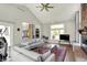 Spacious living room with a fireplace, vaulted ceilings, and connected to the kitchen area at 7531 Normandy Blvd, Indianapolis, IN 46278