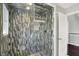 Shower with glass doors features decorative tiled walls and convenient wooden bench at 7531 Normandy Blvd, Indianapolis, IN 46278