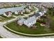 Aerial view of a home featuring a large yard and a lake in the distance with surrounding homes at 805 Harvest Lake Dr, Brownsburg, IN 46112