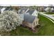 Aerial view showcasing a home with a lush green lawn and beautiful mature trees in a suburban neighborhood at 805 Harvest Lake Dr, Brownsburg, IN 46112
