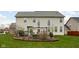Large home backyard with patio, flower beds, green grass, and grill for entertaining at 805 Harvest Lake Dr, Brownsburg, IN 46112