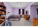 Comfortable bedroom with purple walls, carpeted floor, and view of the neighborhood at 805 Harvest Lake Dr, Brownsburg, IN 46112