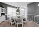 Charming dining room with a round table, white chairs, and a decorative hutch at 805 Harvest Lake Dr, Brownsburg, IN 46112